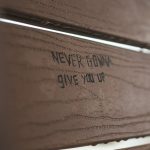 a close up of a wooden door with writing on it